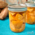 jars of home canned chunks of sweet potatoes on a table